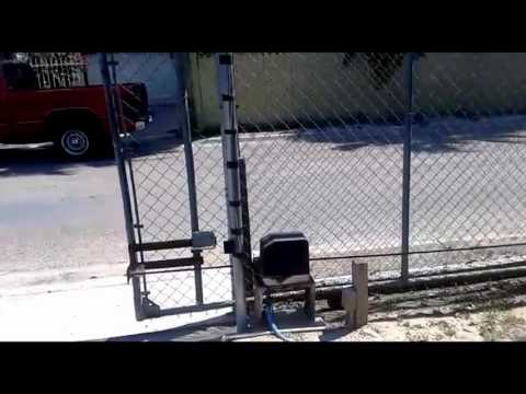 Gate1® Gate opener opening and closing a Chain link gate