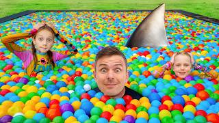 Fun time by the pool! – Alex and the toy shark in the pool