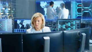 System Monitoring Room Professional Female Operator Observes Correct Functioning of the Facility. |