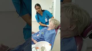 Taking the measurements for the insertion of Ryles Tube to feed patient.