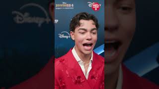 Malachi Barton approves of Meg Donnelly's look and date at the "zombies 4" premiere