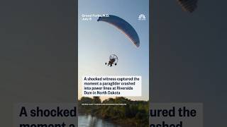 A shocked witness captured the moment a paraglider crashed into power lines in North Dakota