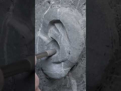 Carving an ear in black Portoro marble.