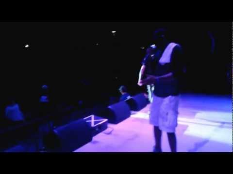 Mic Strange Warns Concert Crowd "Chill... We Strapped"